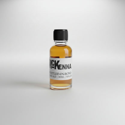 Small bottle of McKenna whiskey on a bar counter with a blurred bar background