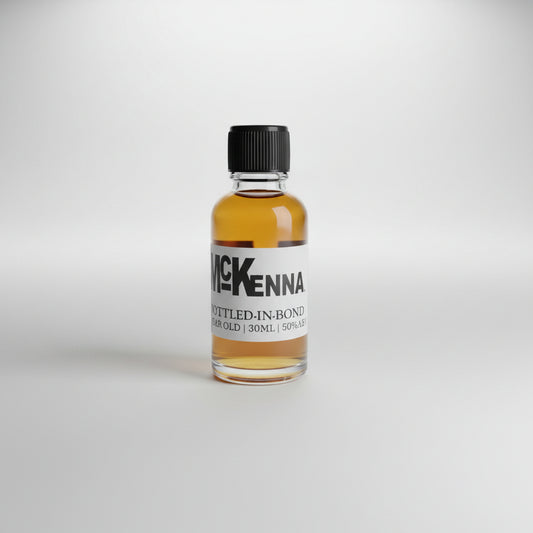 Small bottle of McKenna whiskey on a bar counter with a blurred bar background
