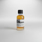 Small bottle of McKenna whiskey on a bar counter with a blurred bar background