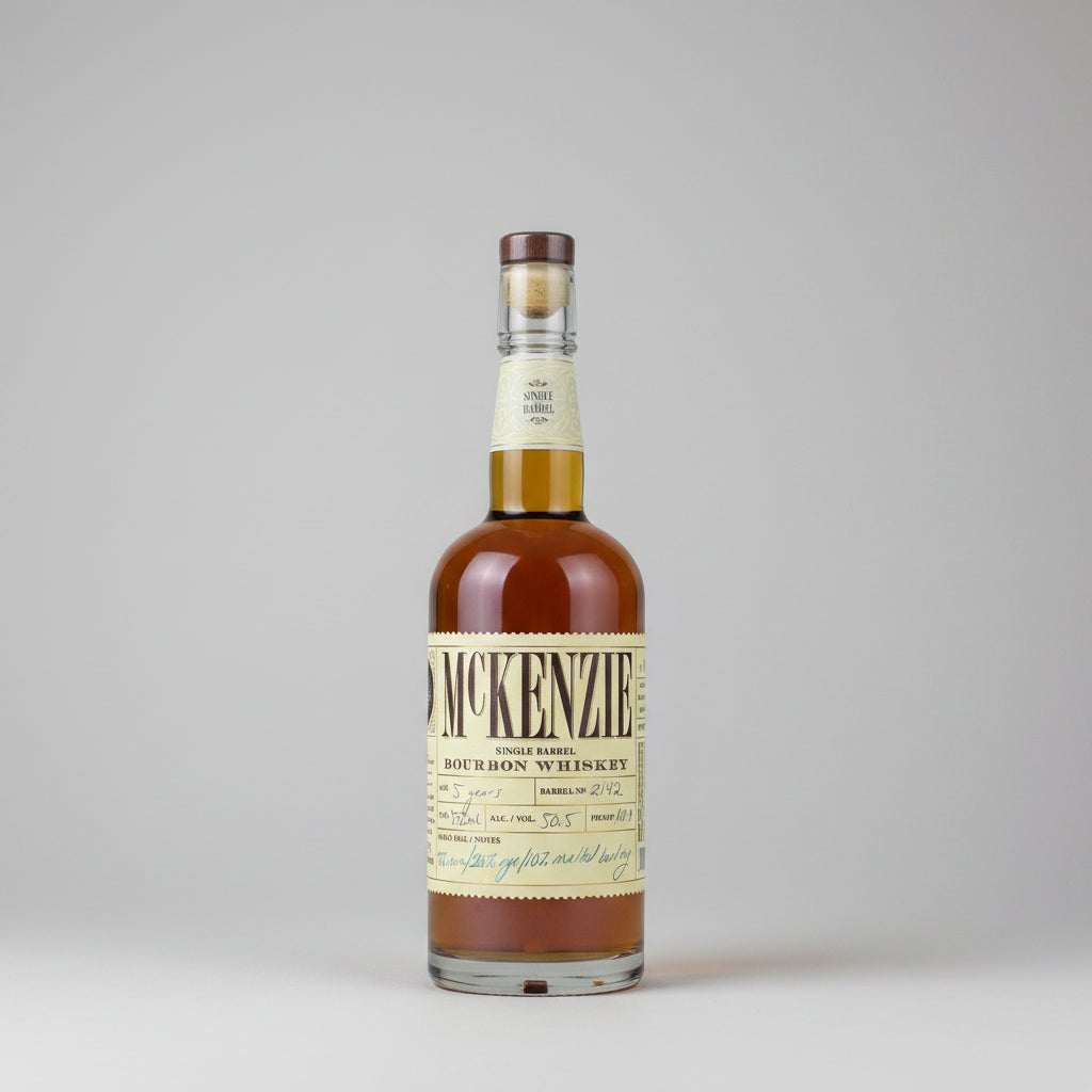 A bottle of McKenzie Single Barrel Bourbon Whiskey with amber liquid, a cream-colored label, and a brown cap, shown against a plain white background.