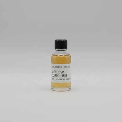 Small bottle of Mellow Corn Bib with a black cap on a light gray background
