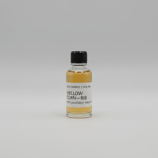 Small bottle of Mellow Corn Bib with a black cap on a light gray background