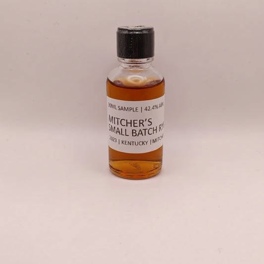 Small bottle of Mitcher's Rye whiskey sample on a beige background