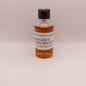 Small bottle of Mitcher's Rye whiskey sample on a beige background
