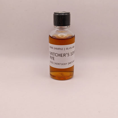 Small bottle of Mitcher's 10 Year Rye whiskey sample on a beige background
