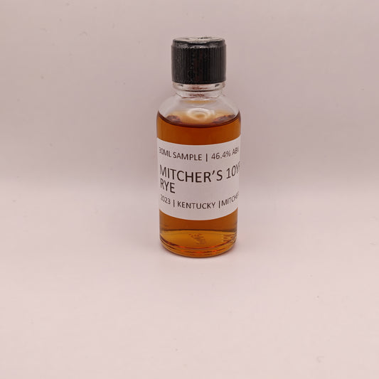 Small bottle of Mitcher's 10 Year Rye whiskey sample on a beige background