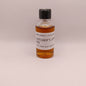 Small bottle of Mitcher's 10 Year Rye whiskey sample on a beige background