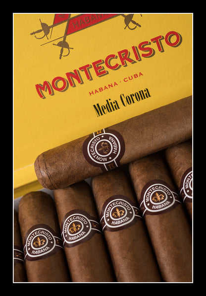 Montecristo Habana - Cuba Media Corona cigars and their yellow packaging box, presented in a clean product shot with a black border.