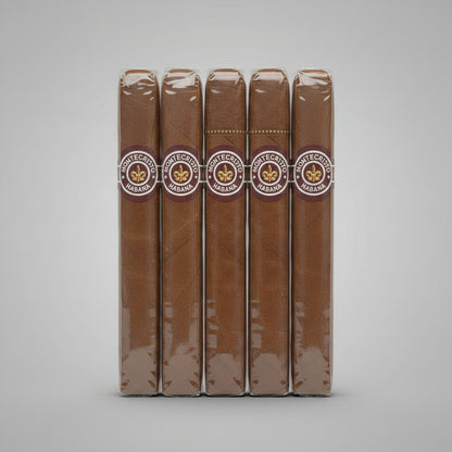 5 brown cigar shown vertically against a light gray gradient background, wrapped in clear plastic with a circular band featuring the text 'CIGAR DEL MONTE'.