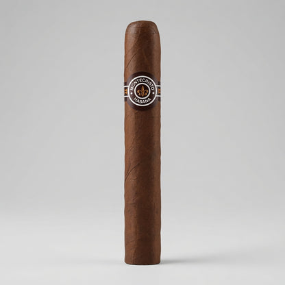 A single Montecristo 3 No. 3 brown cigar standing upright against a light gray studio background, featuring a circular Montecillo Habano band with a gold and silver emblem.