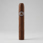 A single Montecristo 3 No. 3 brown cigar standing upright against a light gray studio background, featuring a circular Montecillo Habano band with a gold and silver emblem.