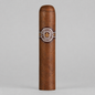 A single Montecristo Habana cigar standing upright against a neutral light gray background. The cigar has a rich medium-brown textured wrapper and features a circular brown paper band with gold and white details displaying the Montecristo logo.