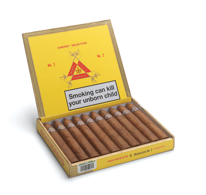 An open box of Montecristo No. 2 cigars on a white background, showing the yellow interior with a prominent health warning label on the lid.