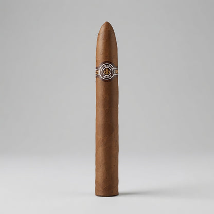 A single brown cigar standing upright on a light gray studio background, featuring a silver and black band with a circular logo near the top.