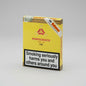A yellow Montecristo Habanos cigar box on a light gray studio background, with a large smoking-health warning label on the front and a diagonal Habanos seal sticker.