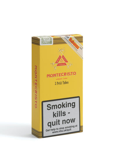 A yellow Montecristo Petit Tubercule cigarette pack box with red branding and a large smoking-health warning label on the front, photographed on a light gray background.