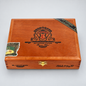 A wooden cigar humidor box with a warm reddish-brown finish, featuring the 'My Father Cigars' crest on top, a gold clasp, and branded bands on the lid, photographed on a light gray background.