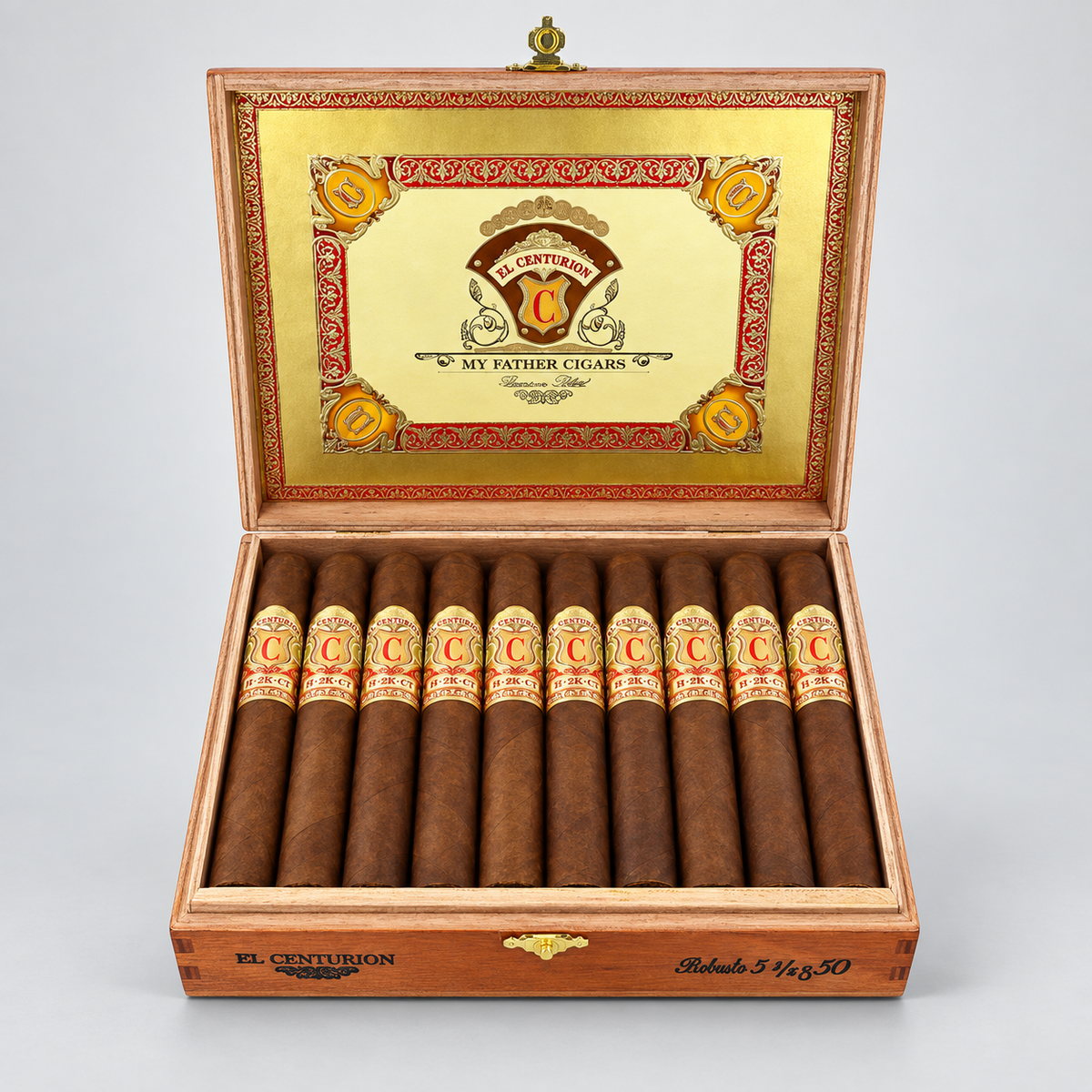 An open wooden cigar box displaying ten cigars inside, with the lid open to show a gold interior panel featuring the El Centurion logo and the text 'My Father Cigars'.