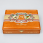 A premium wooden cigar box from La Opulencia, featuring a polished orange-brown wood finish, a decorative beige and red paper band with illustrations of birds and flowers, and gold foil lettering.