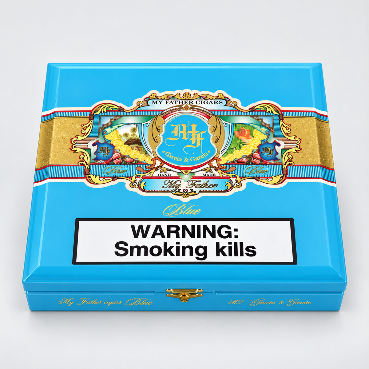 A bright blue cigar box with ornate gold, red, and white decorative artwork across the top and a large white warning label reading 'WARNING: Smoking kills' on the front. The visible brand text includes 'My Father Cigars' and 'Rumiantes'.