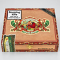 A wooden cigar box labeled 'Flor de las Antillas' by My Father Cigars, shown on a light gray background. The box has ornate red and gold decorative borders, a large central illustrated label, a black diagonal ribbon reading 'MY FATHER CIGARS,' a white square panel with a smoking-health warning sticker, and a small side sticker.