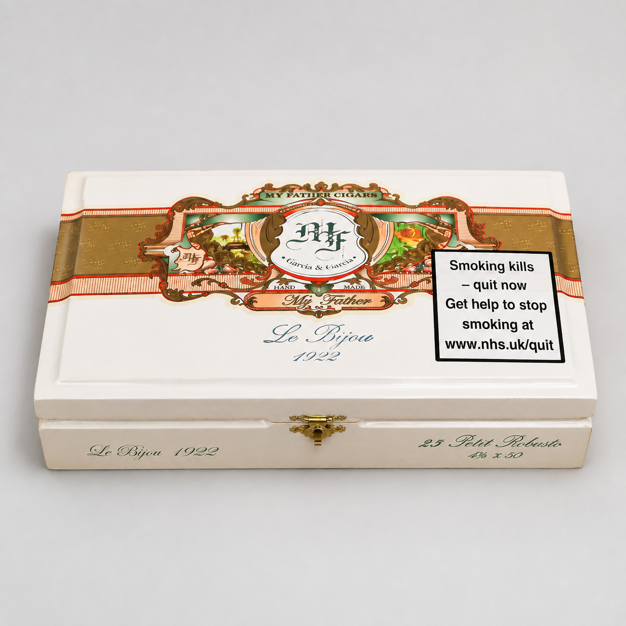A vintage-style white cigar box with gold and red decorative bands, featuring the brand name 'My Father' and 'Le Roi 1922'. A black warning label about smoking is printed on the front.