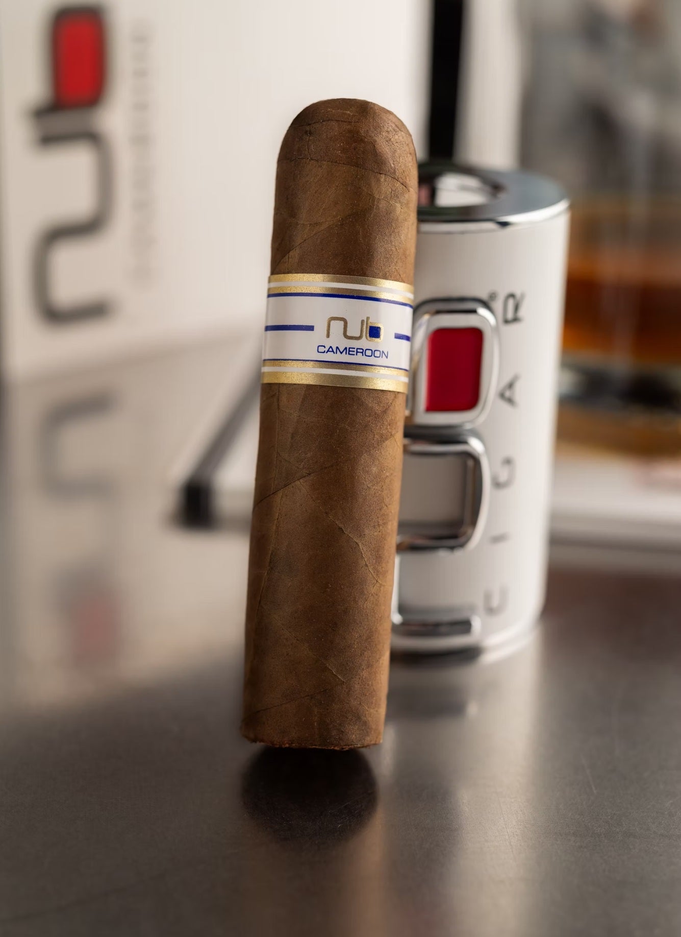 Cigar with a visible NUB brand label on a metallic surface