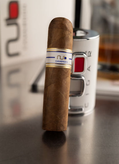Cigar with a visible NUB brand label on a metallic surface
