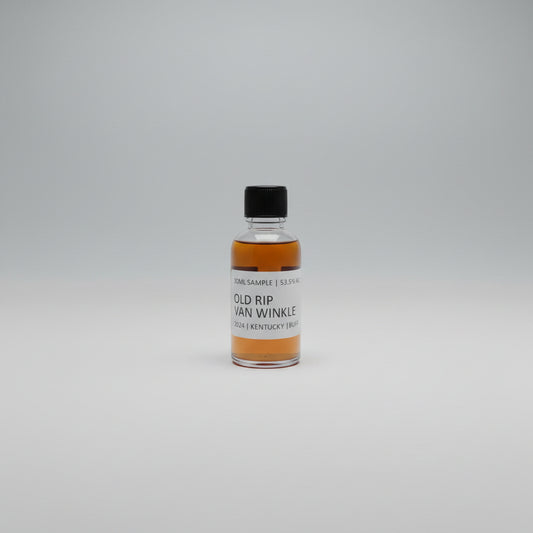 Bottle of Old Rip Van Winkle whiskey on a reflective surface with blurred background