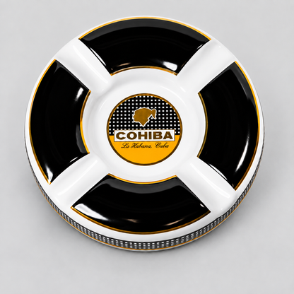 A round black and white divided cigar ashtray with gold trim, featuring a central logo for 'COHIBA La Habana Club'.