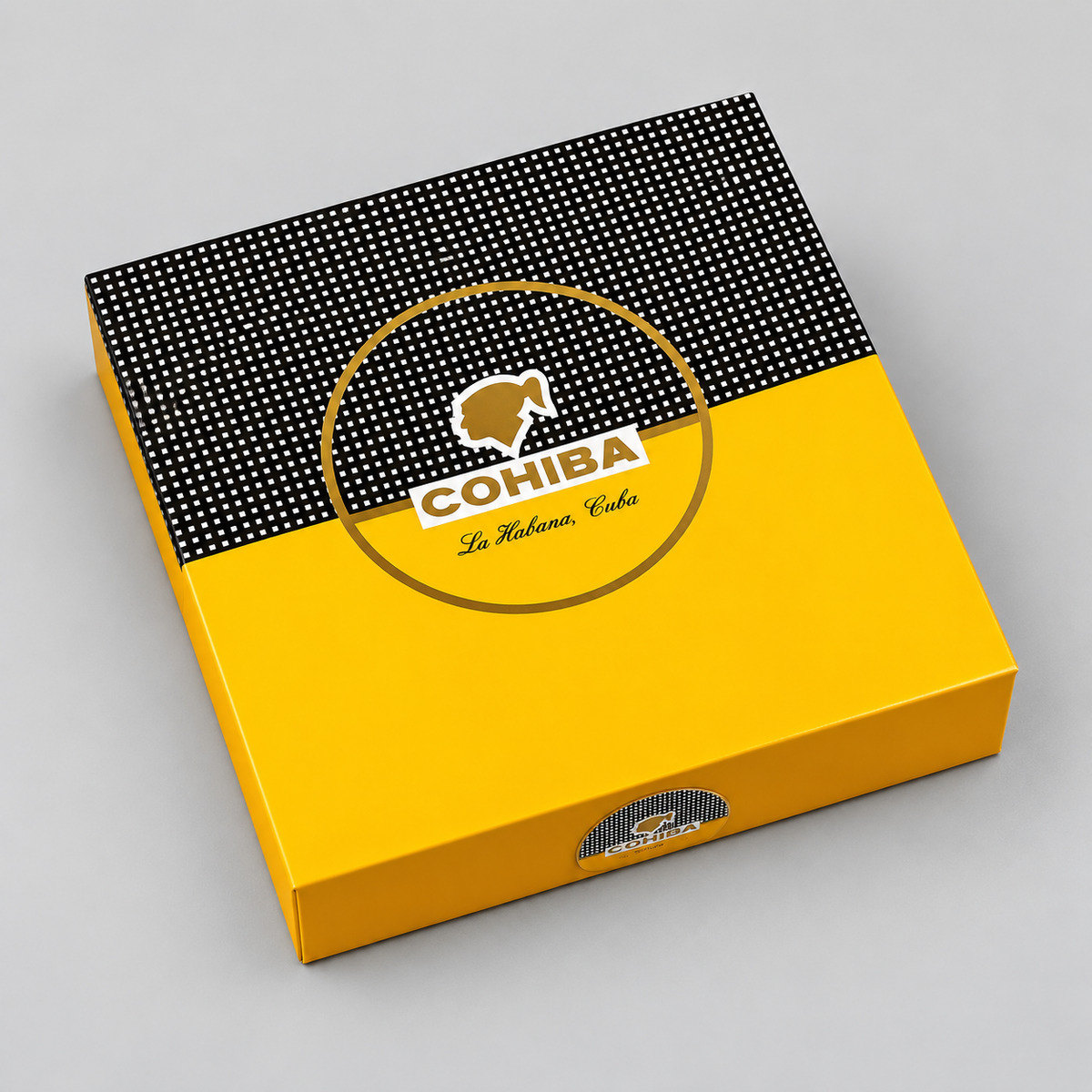 A square COHIBA cigar box in yellow and black, photographed at an angle on a neutral gray background. The top half of the lid is black with a white dotted pattern, and the bottom half is solid yellow.