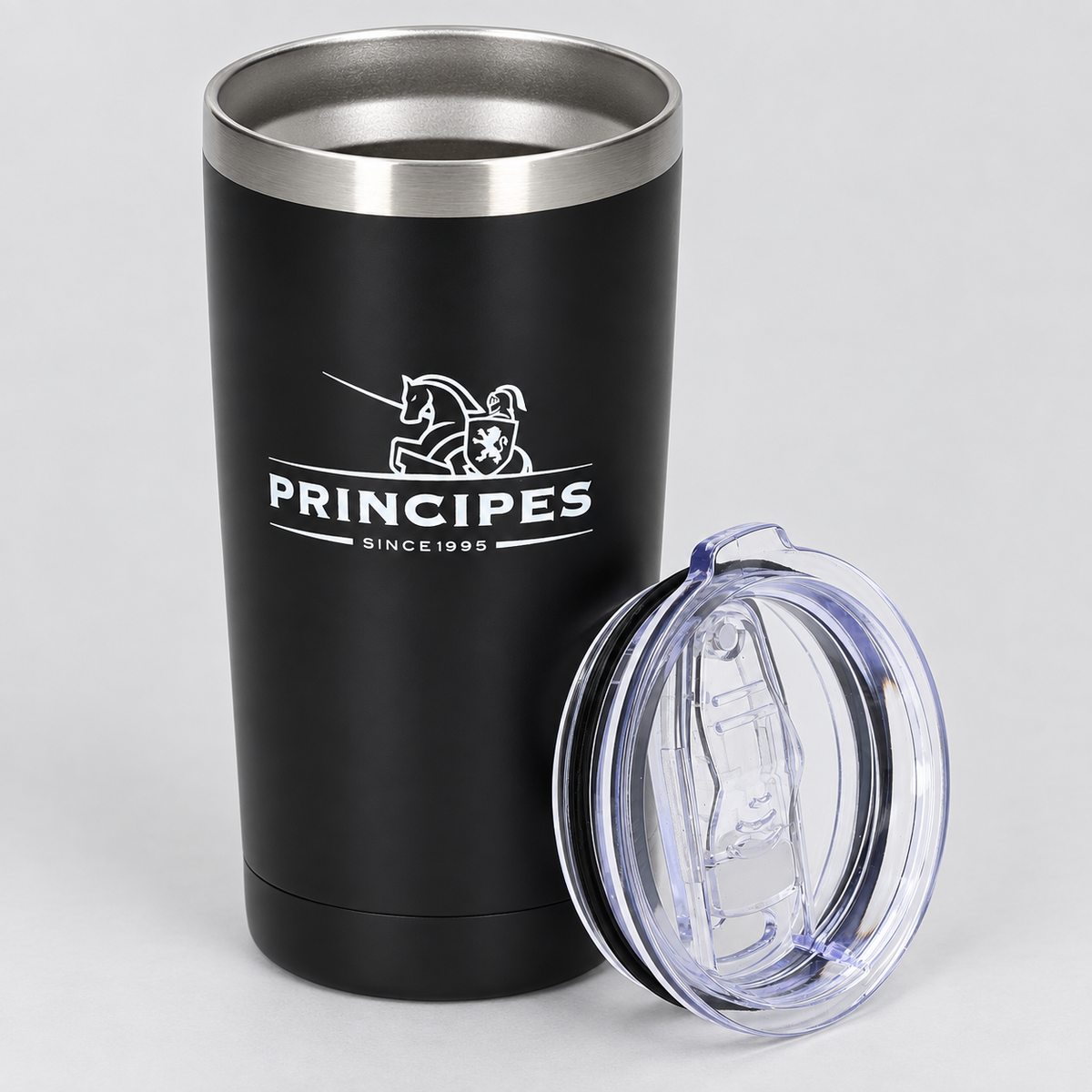 A matte black insulated travel tumbler with a stainless steel rim, featuring a white printed Principes logo on the front. A clear plastic lid with a clear silicone straw insert is shown beside it on a light gray background.