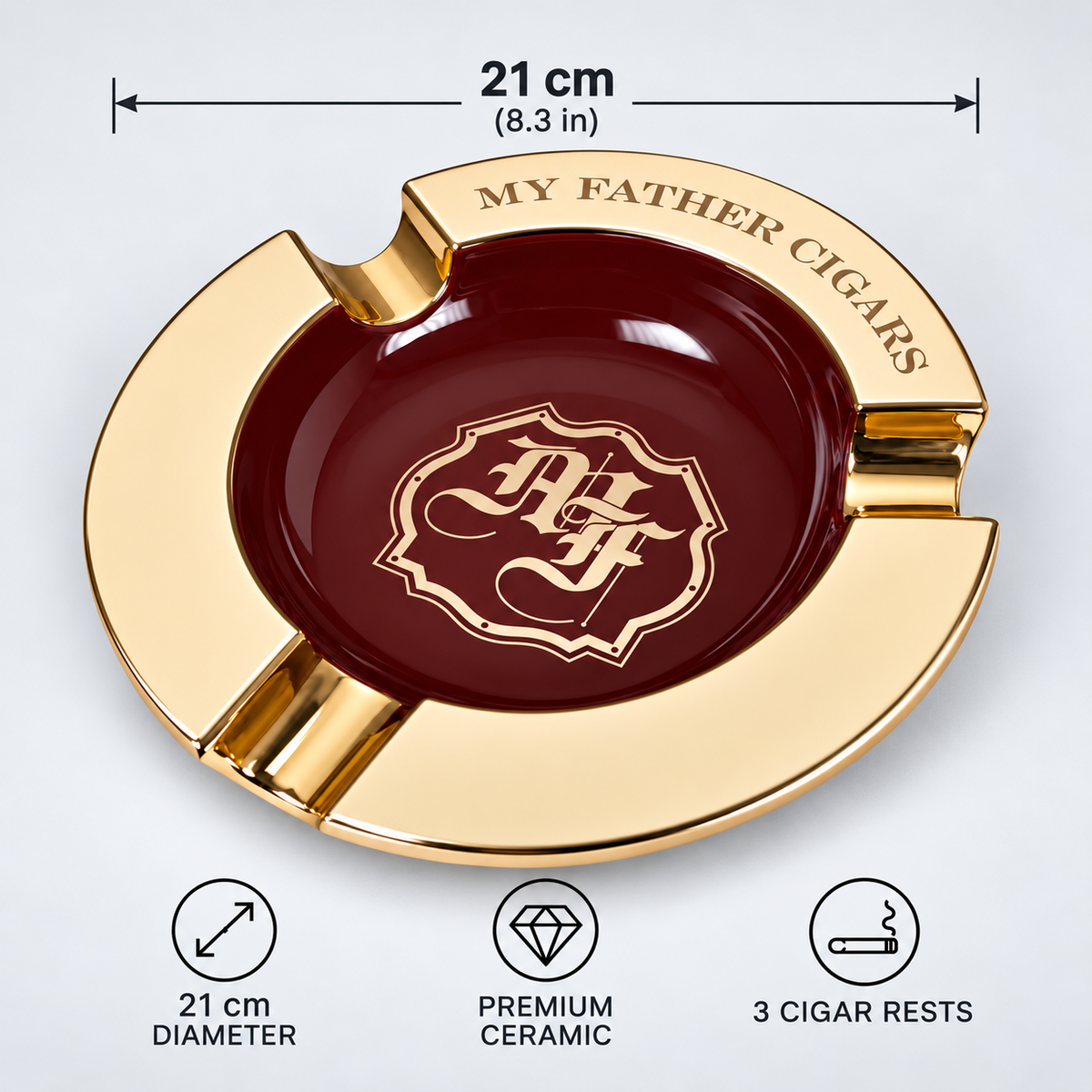 A round gold and dark red ceramic cigar ashtray with the text 'MY FATHER CIGARS' and a monogram crest in the center. The image includes dimension markers showing 21 cm (8.