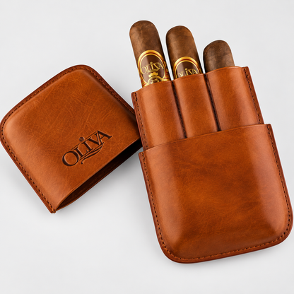 A brown leather cigar case shown open with three cigars inserted. The case lid, placed to the left, is embossed with the brand name 'OLIVA'.