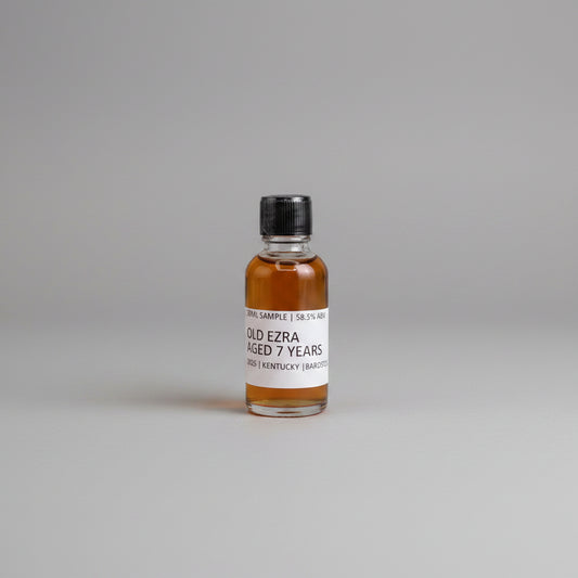 Small bottle of Old Ezra aged 7 years whiskey on a pink background