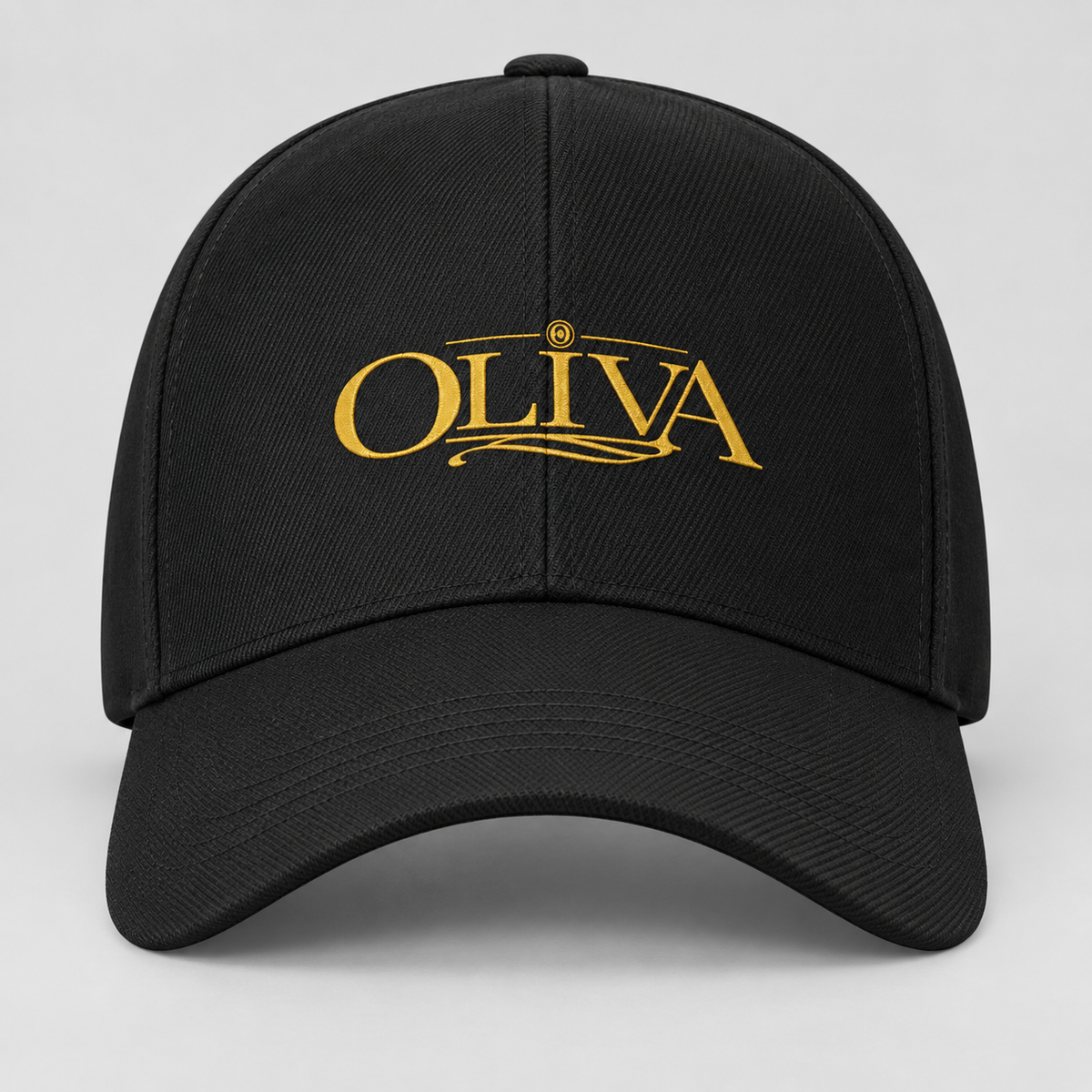 A black baseball cap with a curved brim, featuring the word 'OLIVA' embroidered in gold on the front, set against a light gray background.