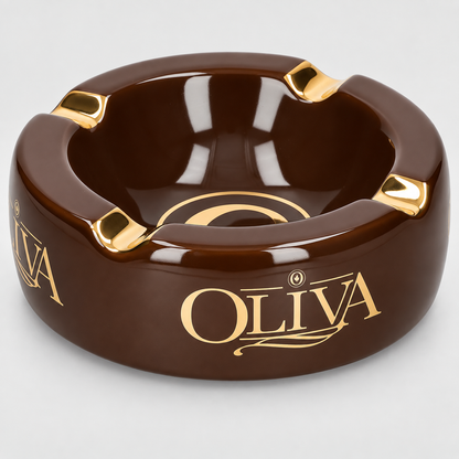 A glossy dark brown ceramic ashtray with gold accents and the brand name 'OLIVA' printed in gold on the front, set against a light gray background.