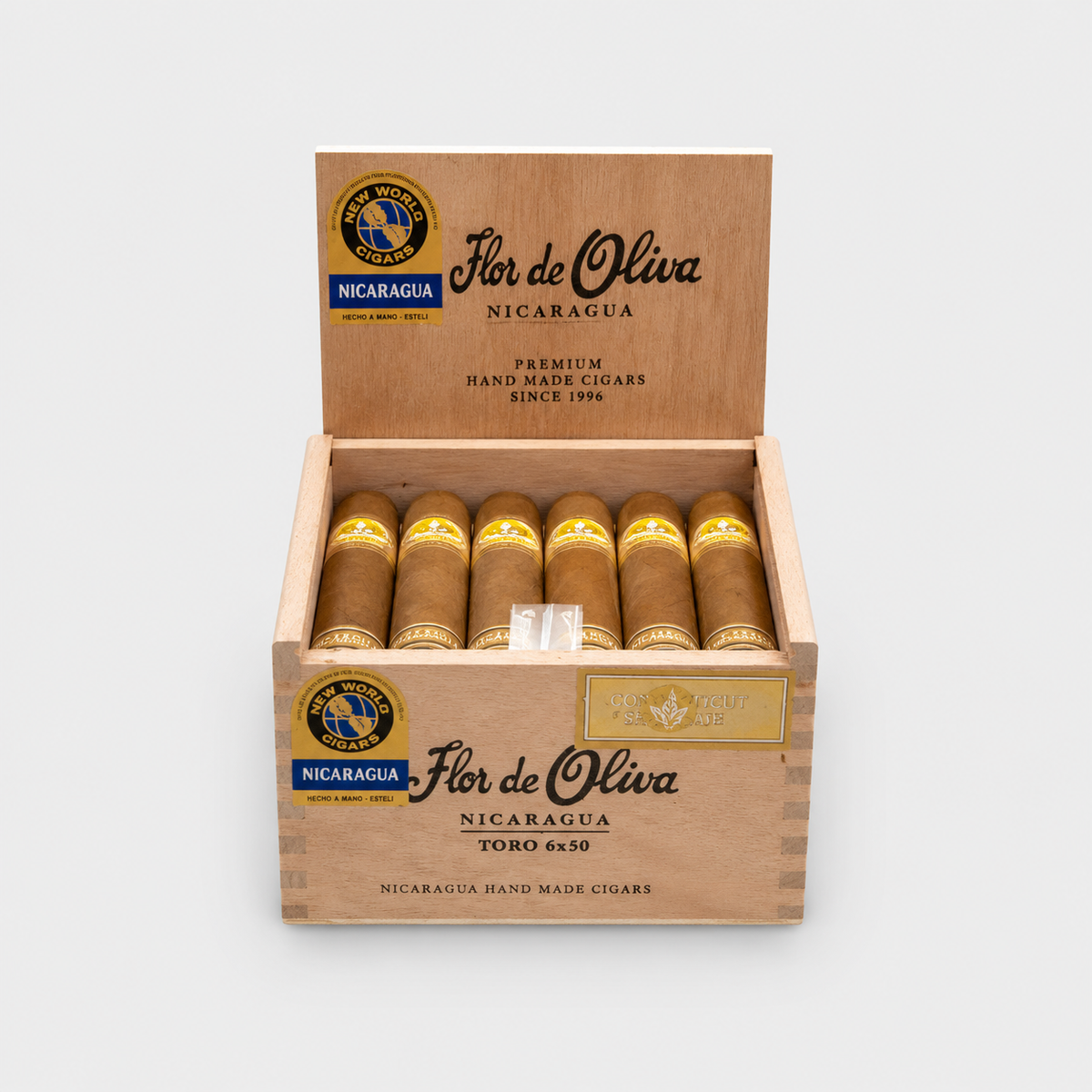 An open wooden cigar box labeled Flor de Oliva Nicaragua Toro 650, containing ten cigars with gold bands, photographed on a clean light gray background.