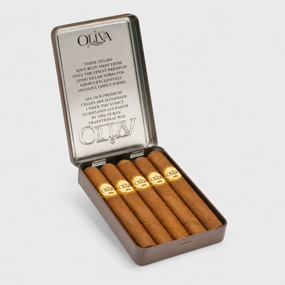 An open silver metal cigar tin on a light gray background, containing six brown cigars with gold rings. The brand name OLIVA is clearly visible on both the inside lid and the cigar bands.