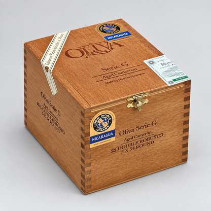 A wooden cigar box for Oliva Serie G cigars, made from Nicaraguan Agado Camero, with a gold clasp and branded seals, shown on a light gray background.