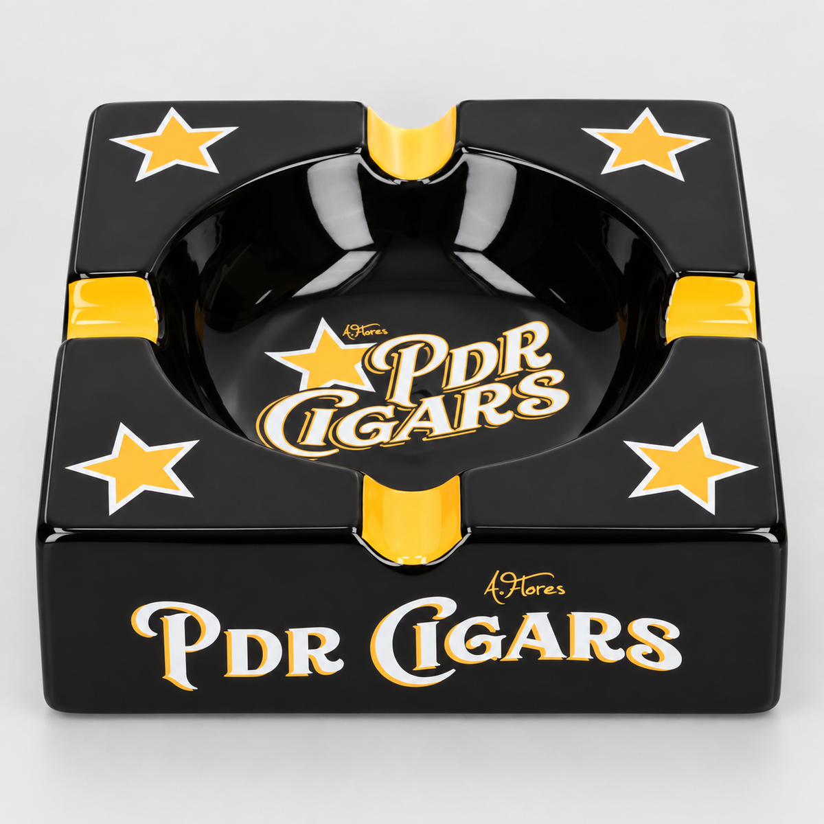 A square black ashtray with gold and white PDR Cigars branding, featuring four gold stars on the sides and a glossy finish.