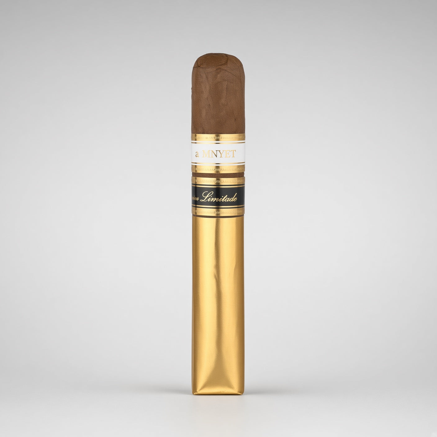 A single cigar in its gold wrapper, standing upright against a neutral light gray background. The wrapper features a white band with gold lettering that reads '4 MAYET' and 'Cigars', along with a black band with gold script.