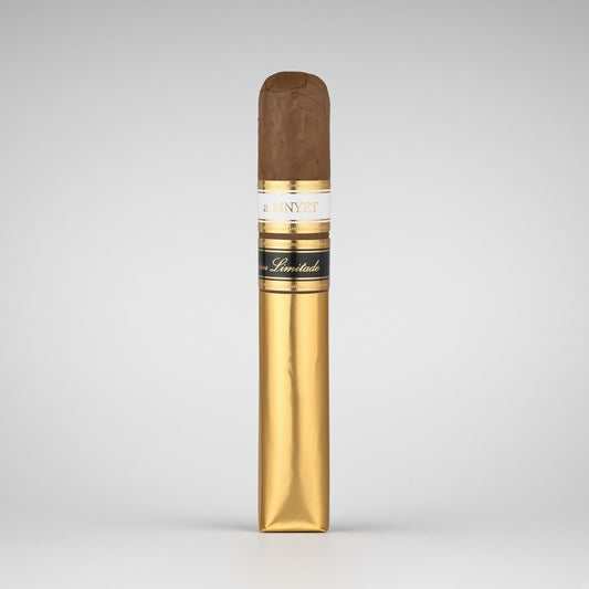 A single cigar in its gold wrapper, standing upright against a neutral light gray background. The wrapper features a white band with gold lettering that reads '4 MAYET' and 'Cigars', along with a black band with gold script.
