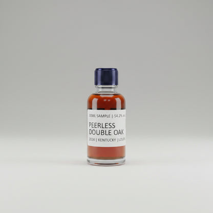 Bottle of Peerless Double Oak bourbon on a bar with other bottles in the background.
