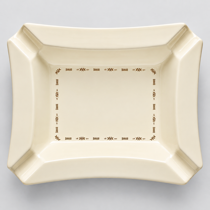 An off-white ceramic serving platter with a brown decorative border, photographed from directly above on a neutral gray background.