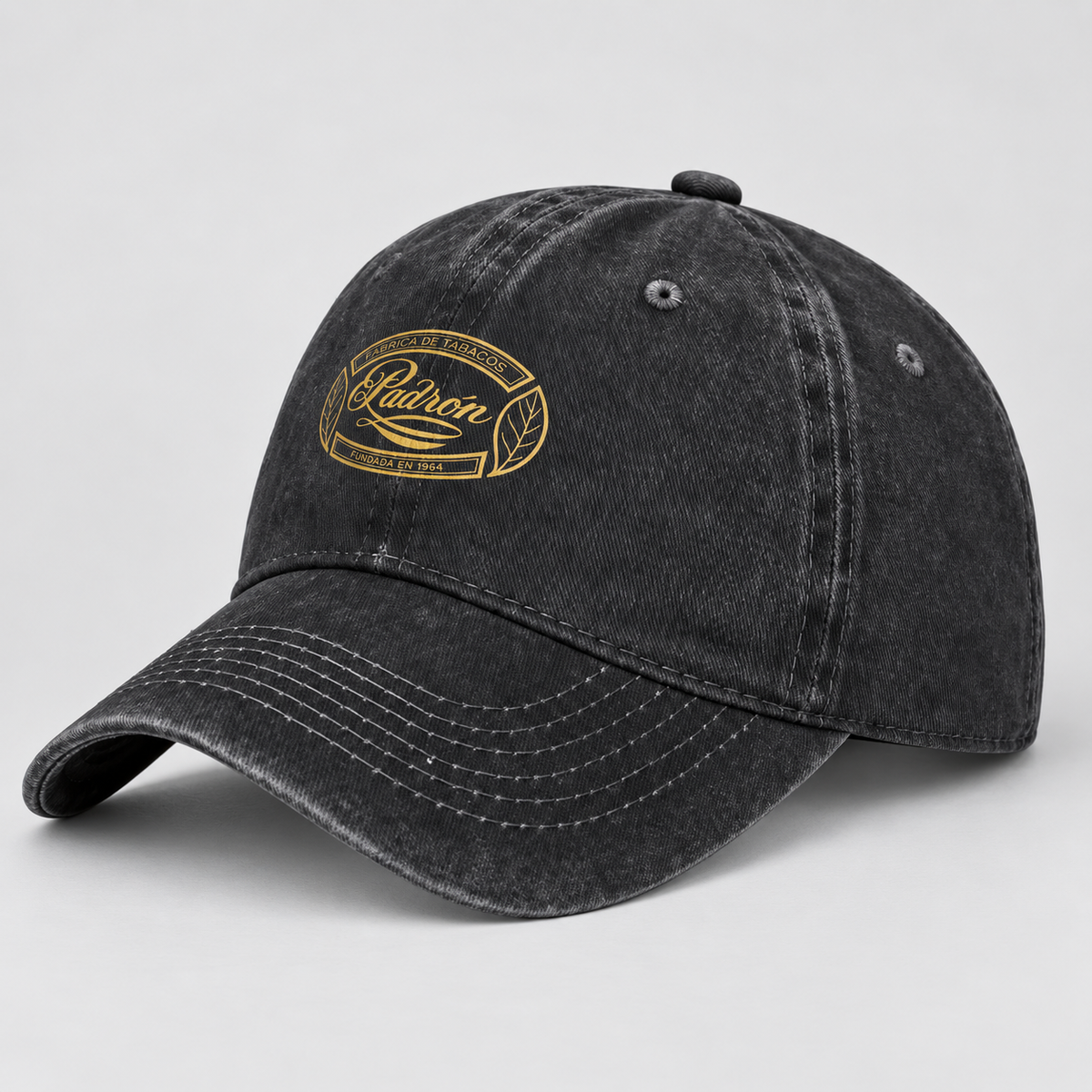 A dark gray washed cotton baseball cap with a gold embroidered oval logo on the front that reads 'Padron' and 'Agricultural Products'.