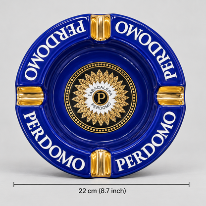 A round blue and gold ceramic Perdomo ashtray with a dimension marker indicating a diameter of 22 cm (8.7 inches) on a light gray background.