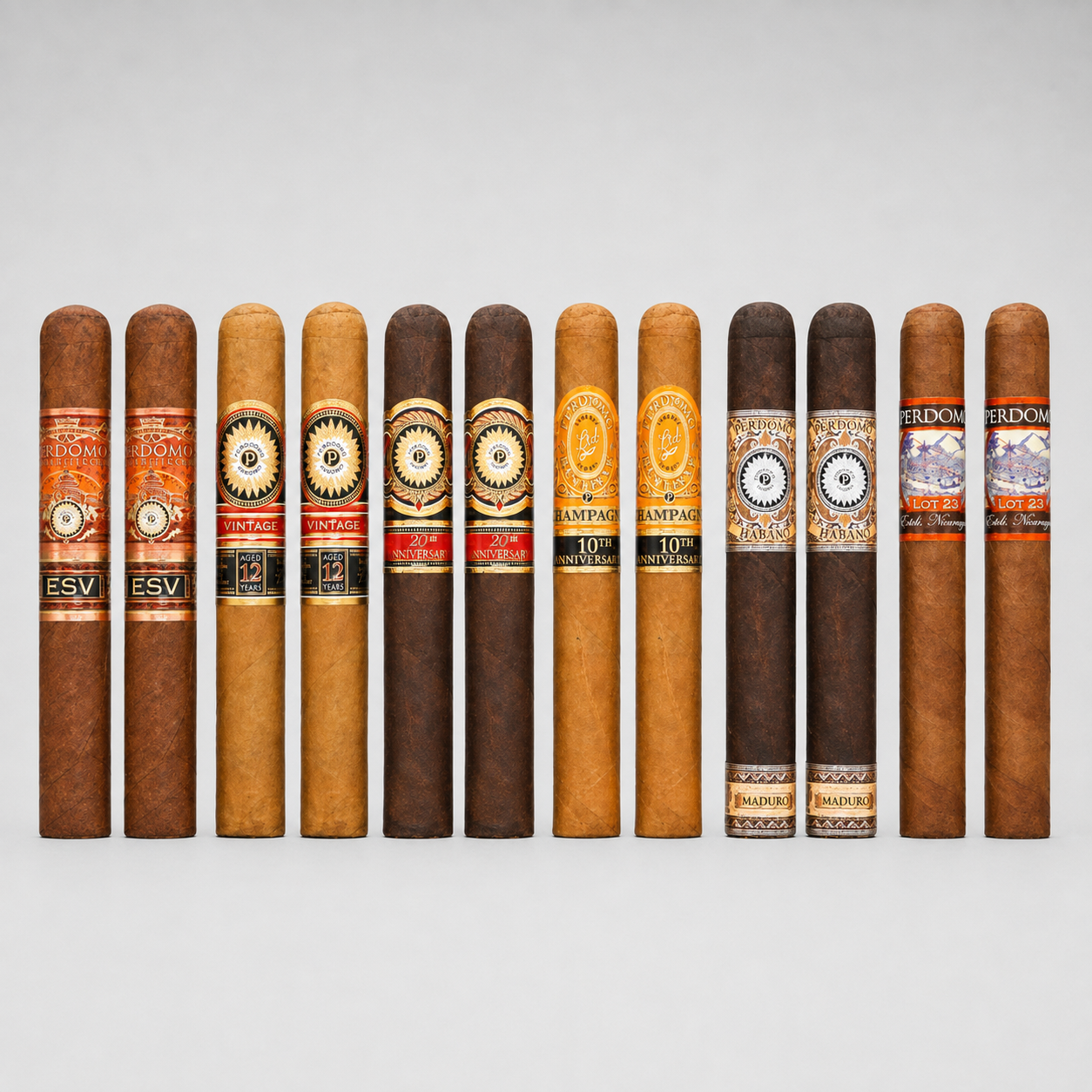 A row of ten cigars arranged upright against a light gray studio background, showing different shades of brown and tan tobacco with colorful bands in orange, gold, red, and white. Several bands display the brand name 'Friedon'.