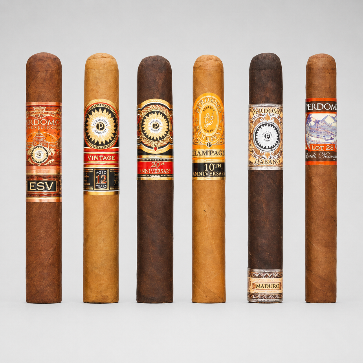 Six cigars in different shades of brown and tan, lined up vertically against a light gray background. Each cigar features a distinct, colorful paper band with text such as 'ESV', 'VINTAGE', '20th Anniversary', 'Champagne', '10th Anniversary', and 'Maduro'.