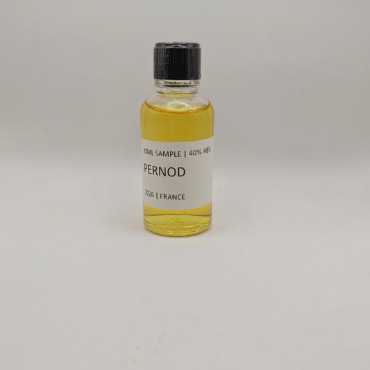 Small bottle of Pernod with a black cap on a light gray background